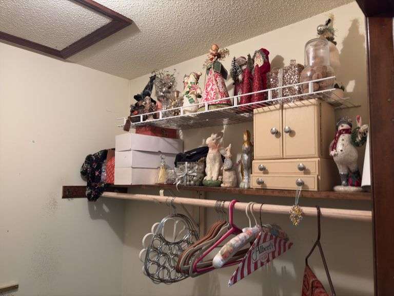 Contents of bedroom 1 closet include holiday decor, empty jewelry box, hangers, etc The white boxes are empty! image