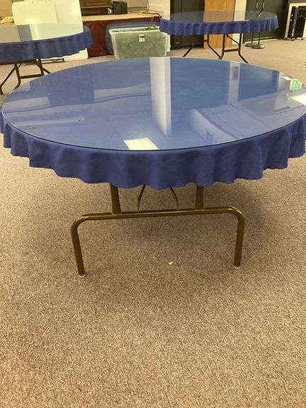 60” Round folding table with glass top and blue tablecloth image