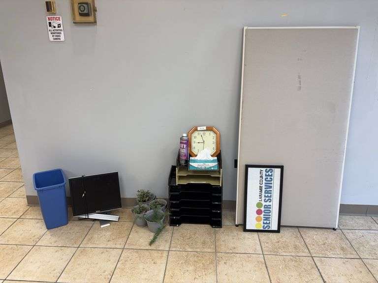 Dell monitor, office desk supplies, faux flowers, trash can, sign, room panel image