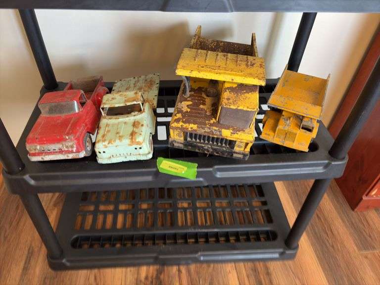 Four sand box toys-small Ertl dump truck, two Tonka pick ups and large Tonka dump truck image