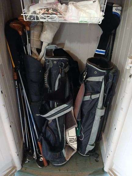 3 golf bags, club covers, balls and a variety of assorted clubs image