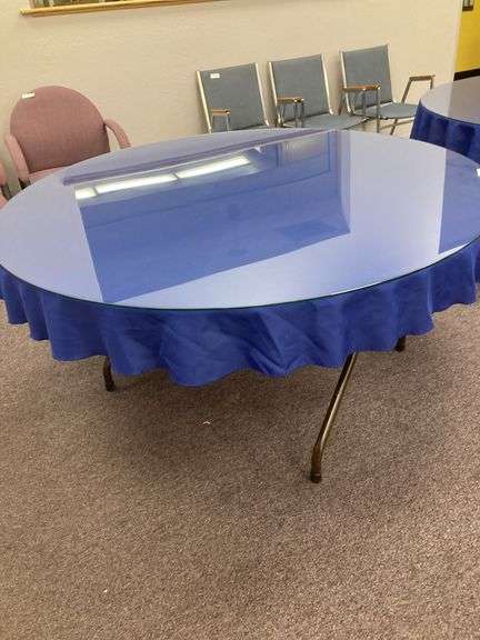 60” Round folding table with glass top and blue tablecloth image