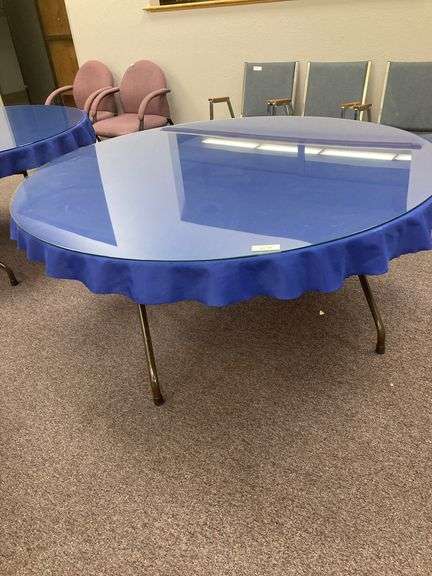 60” Round folding table with glass top and blue tablecloth image