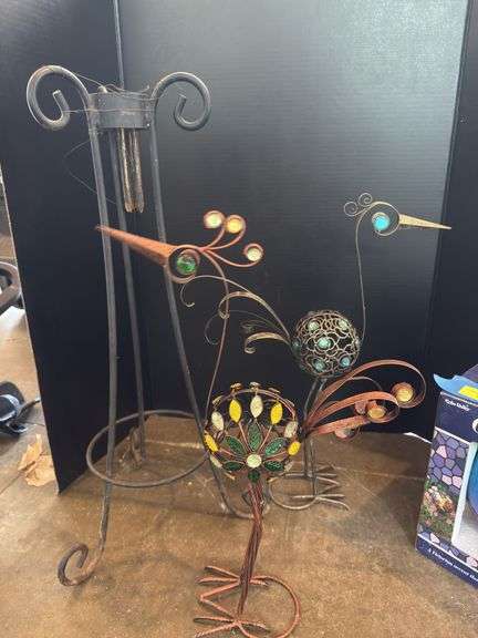 Two decorative yard birds and gazing ball with stand