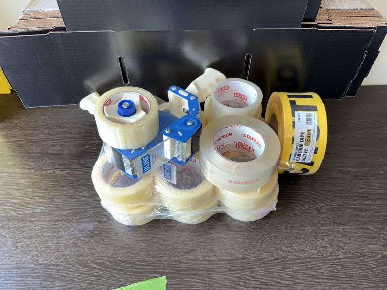 Quantity of Staples brand packing tape, dispensers, boxes, 500’ roll CAUTION tape