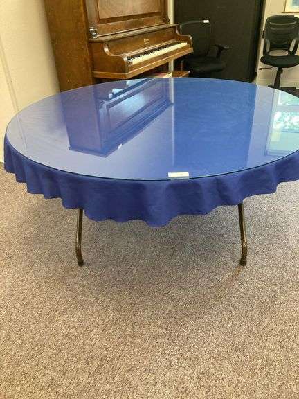 60” Round folding table with glass top and blue tablecloth image