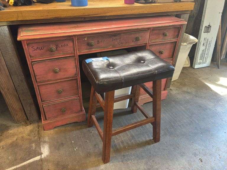 Pink desk used in woodshop and small padded bench image