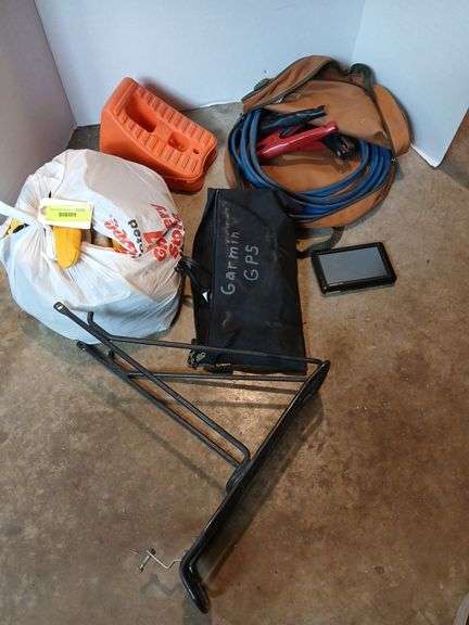 Bag of gloves many new, bike rack, jumper cables and wheel chocks image