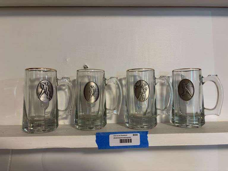 Four glass beer mugs with sports medallions image
