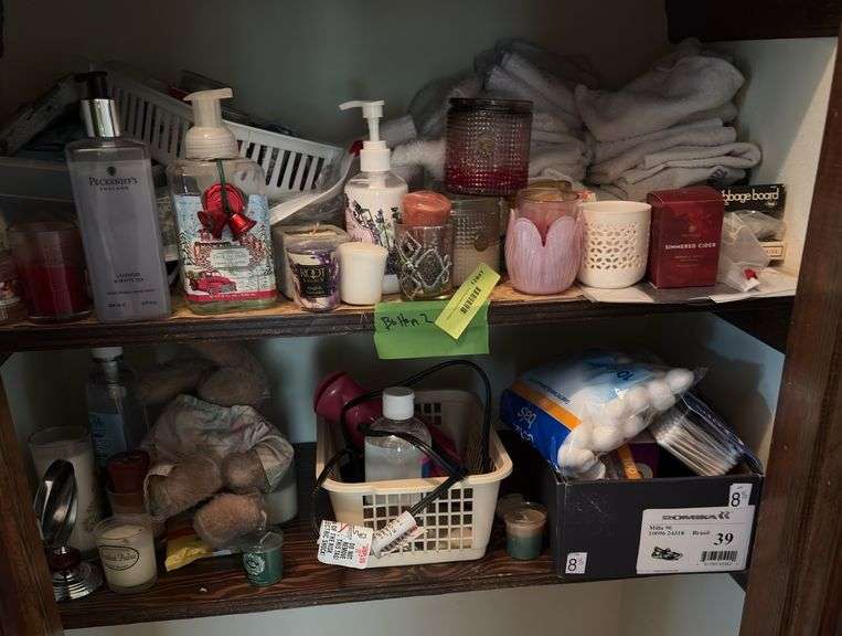 Bottom two shelves includes many candles, soaps, hand towels, etc image