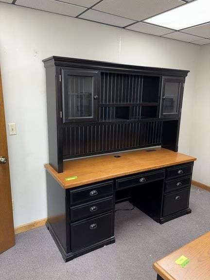 24D x 68L x 72H two piece credenza with hutch on top Has flip down keyboard tray, three drawers on left side and single door on right . Matches desk in lot 11487