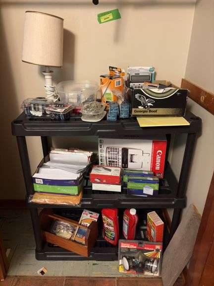 Black plastic shelf with contents-office supplies, table lamp, batteries, Sevin, etc image