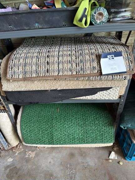 Shelf and all includes many rugs, electric leaf blower, yard flags, lawn edging, yaktrax