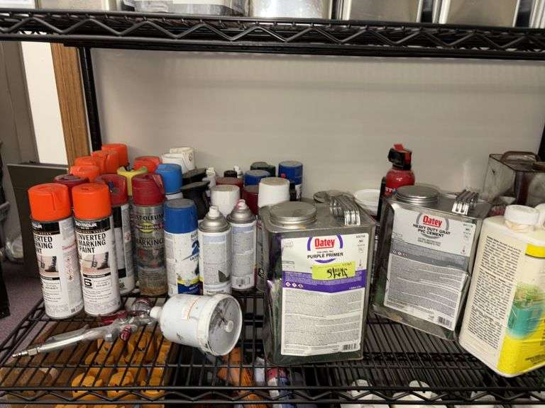Shelf full of paints, paint gun, PVC primers, PVC cements, etc Most have been opened image