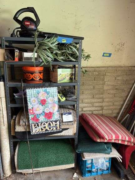 Shelf and all includes many rugs, electric leaf blower, yard flags, lawn edging, yaktrax image