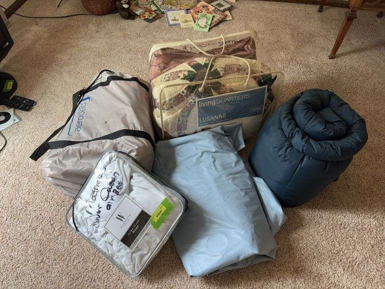 Air beds (one marked queen), sleeping bag, queen comforter and queen bedspread image