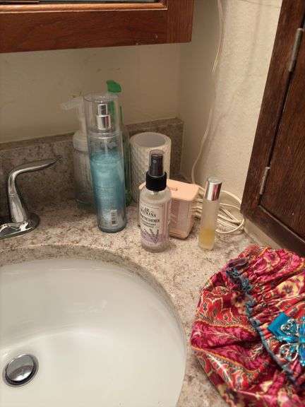 Contents of two baths includes cleaning supplies, bandaids, scales, rugs, etc