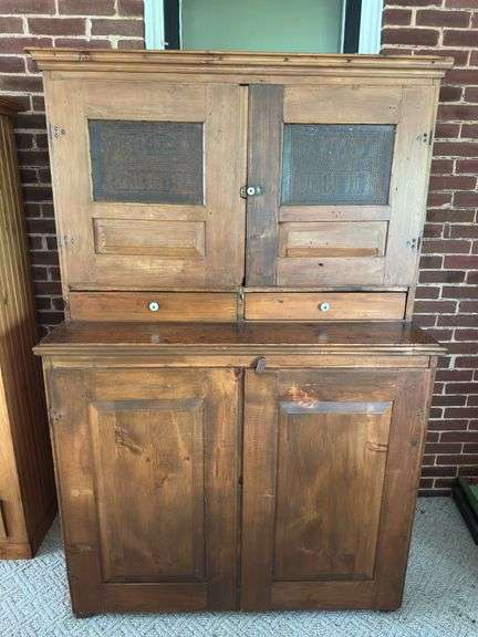 Amazing 1871 wedding cupboard, punched tin top doors with Bride and Groom initials and date Left door reads "ALS 1871" right door reads "AMD 1871" Doors have mortise joints with wood peg joinery, raised panel, bottom doors same, inside of top is constructed with shelf to hang flatware, hinges are mortise into center of boards and screwed, not surface mounted. This is a great piece, the closer you look the more you appreciate the craftsmanship. Drawers in top section have been reconstructed. ONE piece, bring help image