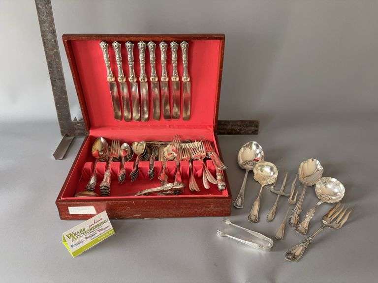 Flatware case with several pieces of flatware, not matching image