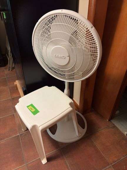 Lasko oscillating fan and small plastic patio table image