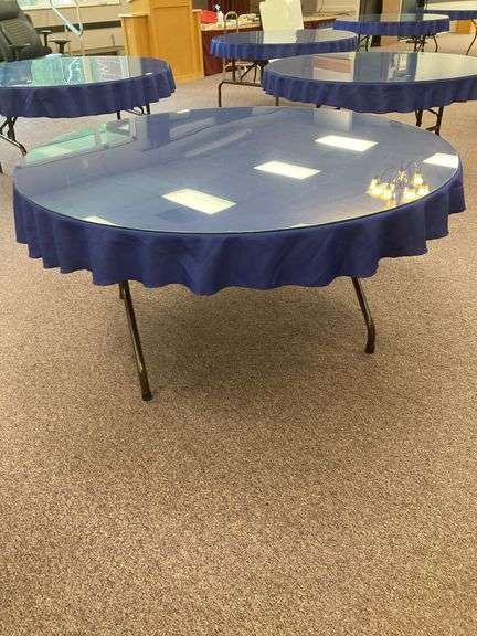 60” Round folding table with glass top and blue tablecloth image