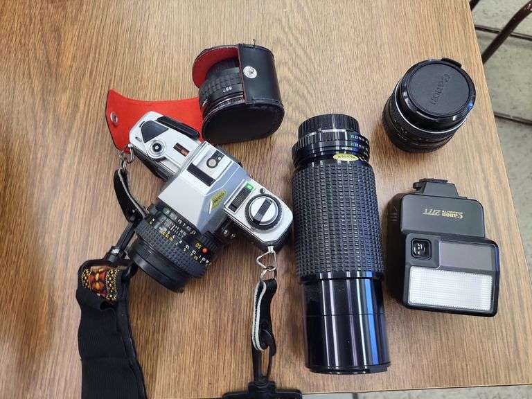 Camera with extra lenses and carry bag image