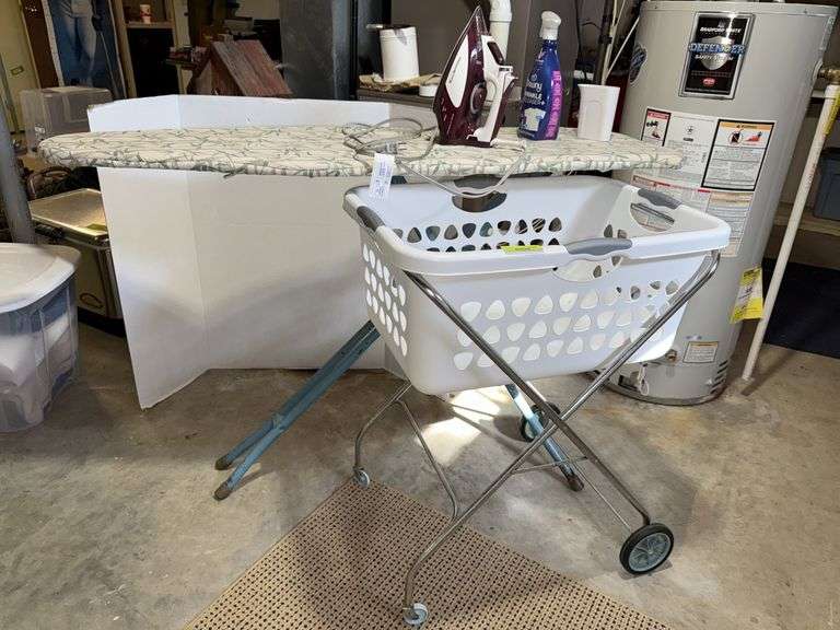 Ironing board, steam iron and rolling laundry basket image