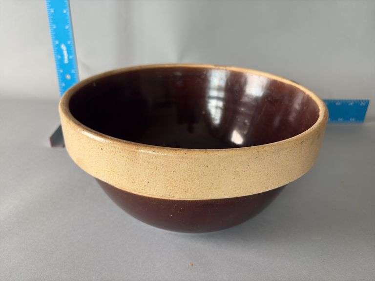 Brown crock bowl with tan rim 12” image