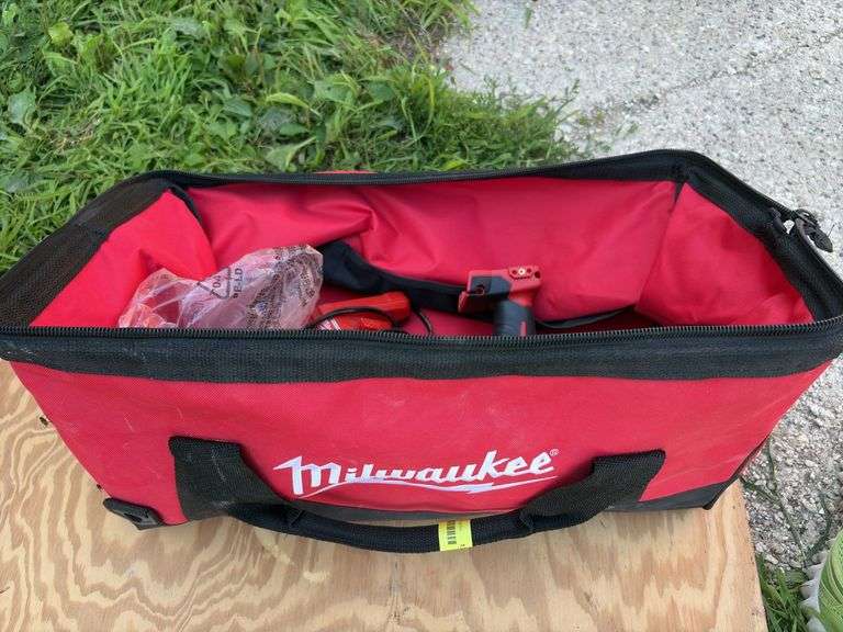 Milwaukee tool bag with 1/2” hammer drill, battery and charger image