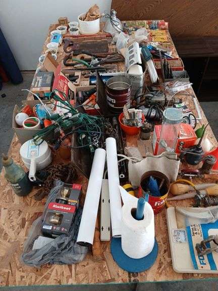 4 x 8 sheet of plywood full of tools and household maintenence items