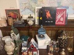 Shelf and contents includes decorative birdhouses, deco scale, bottles, trophies, etc