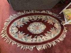 Small oval entry rug, rattan laundry hamper and linens