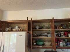 Tupperware, silverplate, cookbooks, glassware, coffee mugs, etc "A" cupboards
