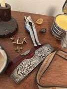Assorted smalls includes merscham style pipe, ice cleats, pocket knives, old razor, bullets, gal on leg nut cracker, ash tray set w/matching holder and more