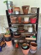 Shelf and all includes many terra cotta planters, baskets, hp printer, sprinkler, tree guards, wire