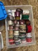 Several rolls of ribbons in totes