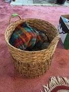 Small oval entry rug, rattan laundry hamper and linens