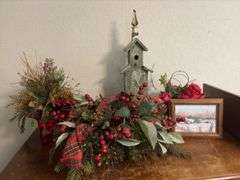 Contents of dresser include holiday decor, wrapping paper, tissue paper, ribbon and bags