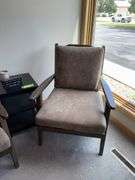 Two padded arm chairs with throw pillows, small side table and decor