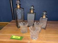 Three decanters and a glass for each one