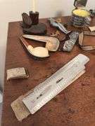 Assorted smalls includes merscham style pipe, ice cleats, pocket knives, old razor, bullets, gal on leg nut cracker, ash tray set w/matching holder and more