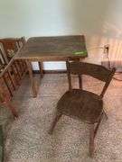 Doll crib, green wicker doll rocker, child’s table and chair