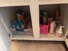 Contents of two baths includes cleaning supplies, bandaids, scales, rugs, etc
