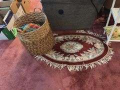 Small oval entry rug, rattan laundry hamper and linens