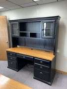24D x 68L x 72H two piece credenza with hutch on top Has flip down keyboard tray, three drawers on left side and single door on right . Matches desk in lot 11487