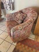 Orange and red toned Southwest style swivel padded armchair
