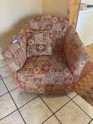 Orange and red toned Southwest style swivel padded armchair