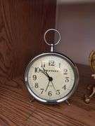Clocks including a very nice metal ornate wind up clock w/ beveled glass, classic alarm clock