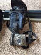 Projector screen, Bushnell 12x32 binoculars, Canon PowerShot A590 digital camera,  Kodak XL33 movie camera