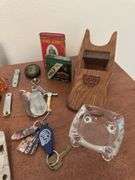 Assorted smalls includes merscham style pipe, ice cleats, pocket knives, old razor, bullets, gal on leg nut cracker, ash tray set w/matching holder and more